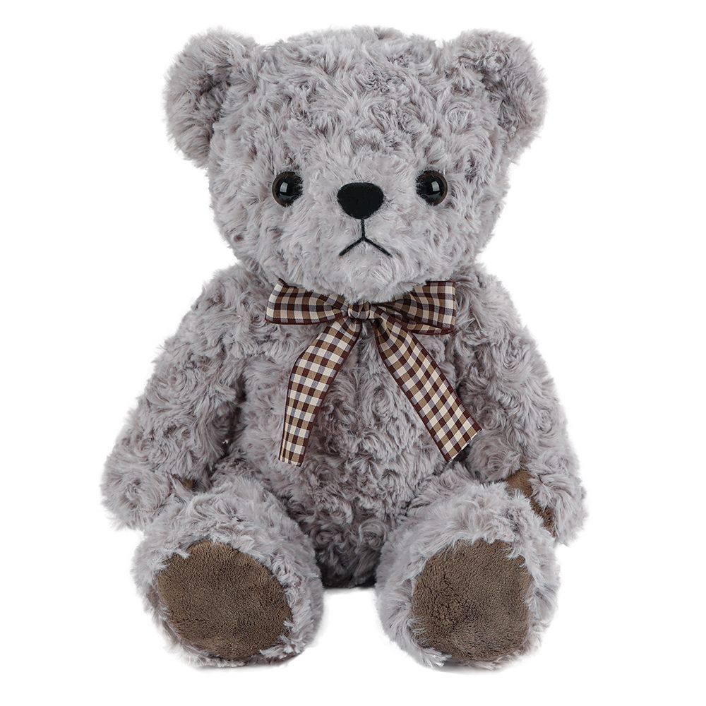 Gray teddy bear with a checked bow